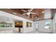 Open concept living room features wood ceilings, tile flooring, updated kitchen, and many windows at 1720 Emerald Dr, Clearwater, FL 33756