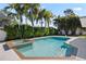 Refreshing pool with a built-in spa and lush tropical landscaping, creating a private backyard oasis at 1720 Emerald Dr, Clearwater, FL 33756