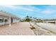 Brick patio extending to waterfront, with well-manicured lawn and view of the docks at 179 Bath Club N Blvd, North Redington Beach, FL 33708
