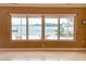 Bright living room featuring large windows offering scenic waterfront views, enhancing the tranquil ambiance at 179 Bath Club N Blvd, North Redington Beach, FL 33708