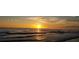 Beautiful sunset at the beach, featuring golden light reflecting on the water and clouds above at 179 Bath Club N Blvd, North Redington Beach, FL 33708