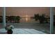 Scenic waterfront view at night, featuring a bright moon and waterfront homes across the canal at 179 Bath Club N Blvd, North Redington Beach, FL 33708