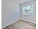 Bright bedroom with a large window providing ample natural light and wood-look floors at 2002 E Hanna Ave, Tampa, FL 33610