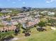 Aerial view showcasing a community with tennis courts, a pool, clubhouse, parking, and lush landscaping at 2017 Skimmer W Ct # 416, Clearwater, FL 33762