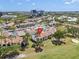 Aerial view showcasing a community with tennis courts, a pool, clubhouse, parking, and lush landscaping at 2017 Skimmer W Ct # 416, Clearwater, FL 33762