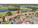 Community aerial view showcasing manicured landscaping, a golf course, lake, tennis court and ample parking at 2017 Skimmer W Ct # 416, Clearwater, FL 33762