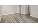Bright bedroom featuring wood-look flooring with dual doorways and baseboard trim at 2017 Skimmer W Ct # 416, Clearwater, FL 33762