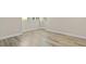 Bright bedroom featuring wood-look flooring and ample natural light with baseboard trim at 2017 Skimmer W Ct # 416, Clearwater, FL 33762