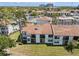 Condominium exterior featuring large windows, balconies, and mature landscaping for privacy at 2017 Skimmer W Ct # 416, Clearwater, FL 33762