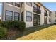 Exterior of condo featuring grass, windows, and a small balcony at 2017 Skimmer W Ct # 416, Clearwater, FL 33762
