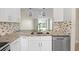 Modern kitchen with stainless steel appliances and view of the outdoor landscape at 2017 Skimmer W Ct # 416, Clearwater, FL 33762