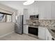 Modern kitchen with stainless steel appliances and white cabinets at 2017 Skimmer W Ct # 416, Clearwater, FL 33762