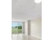 Living room with a sliding glass door and an outdoor view of a pond at 2017 Skimmer W Ct # 416, Clearwater, FL 33762
