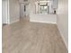 Living room with view of the kitchen and white wood-like floors at 2017 Skimmer W Ct # 416, Clearwater, FL 33762