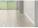 Sunlit living room with sleek wood-look flooring and a sliding glass door at 2017 Skimmer W Ct # 416, Clearwater, FL 33762