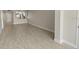 Living room with view of the kitchen and white wood-like floors at 2017 Skimmer W Ct # 416, Clearwater, FL 33762