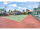 Community tennis court with lush landscaping and a vibrant playing surface at 2017 Skimmer W Ct # 416, Clearwater, FL 33762