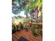 Inviting backyard deck surrounded by lush greenery and mature trees at 2114 W Hanna Ave, Tampa, FL 33604