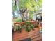 Wooden deck with lush plants and mature trees creates a serene outdoor space at 2114 W Hanna Ave, Tampa, FL 33604