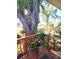 View of the private backyard with an expansive wooden deck and an mature shade tree at 2114 W Hanna Ave, Tampa, FL 33604