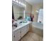 Relaxing bathroom with a tiled soaking tub, a large mirror and a single sink vanity at 2114 W Hanna Ave, Tampa, FL 33604