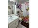 Bright bathroom featuring a decorative shower curtain, single sink vanity and tiled flooring at 2114 W Hanna Ave, Tampa, FL 33604