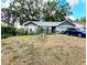 Charming single-story home featuring a well-kept lawn, two-car garage, and mature shade trees at 2114 W Hanna Ave, Tampa, FL 33604