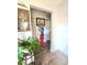 Neutral hallway design with laminate flooring, decorative plants, and bright walls at 2114 W Hanna Ave, Tampa, FL 33604