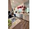 Bright kitchen features stainless steel appliances, white cabinets, and stone countertops at 2114 W Hanna Ave, Tampa, FL 33604