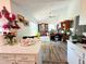 Bright, open-concept living room featuring vaulted ceilings and wood-look flooring at 2114 W Hanna Ave, Tampa, FL 33604