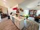 Open concept living room and kitchen area, featuring luxury vinyl plank flooring and white cabinets at 2114 W Hanna Ave, Tampa, FL 33604