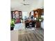 This home office features a vaulted ceiling, a ceiling fan, wood flooring, and custom built-ins at 2114 W Hanna Ave, Tampa, FL 33604