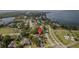 An aerial view of the property highlighting its location near the water and surrounding landscape at 301 1/2 Shore E Dr, Oldsmar, FL 34677