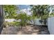 Lush backyard featuring a garden and white fencing at 301 1/2 Shore E Dr, Oldsmar, FL 34677