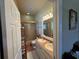 Bathroom featuring double sinks, tile floors, and a glass-enclosed shower in a neutral color palette at 301 1/2 Shore E Dr, Oldsmar, FL 34677