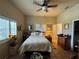 Cozy bedroom with neutral walls, tile floors, ceiling fan, and shuttered windows with natural light at 301 1/2 Shore E Dr, Oldsmar, FL 34677