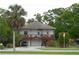 Charming two-story home featuring a spacious front porch and a well-manicured lawn at 301 1/2 Shore E Dr, Oldsmar, FL 34677