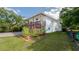 Charming home with a spacious deck and a well-manicured lawn, creating a welcoming outdoor space at 301 1/2 Shore E Dr, Oldsmar, FL 34677