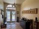 Elegant foyer with tile flooring, decorative decor, and a glass front door with transom window at 301 1/2 Shore E Dr, Oldsmar, FL 34677