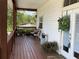 Charming front porch with seating area and decorative plants, creating a welcoming entrance at 301 1/2 Shore E Dr, Oldsmar, FL 34677