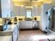 Bright kitchen featuring white cabinets, stainless steel appliances, and tile flooring at 301 1/2 Shore E Dr, Oldsmar, FL 34677