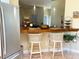 An open kitchen features a breakfast bar and stainless steel refrigerator at 301 1/2 Shore E Dr, Oldsmar, FL 34677