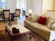 Comfortable living room with light colored tile floors, a plush sofa, and decorative details at 301 1/2 Shore E Dr, Oldsmar, FL 34677