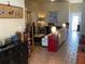 Bright living room featuring tan walls, tile flooring, artwork, and comfortable seating at 301 1/2 Shore E Dr, Oldsmar, FL 34677