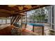 Screened-in pool and patio area with lush landscaping and an inviting outdoor dining space at 301 1/2 Shore E Dr, Oldsmar, FL 34677