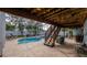Covered patio overlooking a screened-in pool with lounge chairs, perfect for outdoor entertainment at 301 1/2 Shore E Dr, Oldsmar, FL 34677