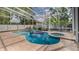 Inviting screened-in pool with an integrated spa, providing a luxurious and relaxing outdoor experience at 301 1/2 Shore E Dr, Oldsmar, FL 34677