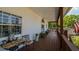 Inviting porch with seating area, offering a relaxing outdoor space with views of the surrounding landscape at 301 1/2 Shore E Dr, Oldsmar, FL 34677