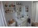 Bathroom featuring a single sink vanity, wall decor, and ample storage space at 3302 Eisenhower Dr, Holiday, FL 34691