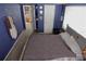 This bedroom features a neutral gray carpet and decoratively adorned blue walls at 3302 Eisenhower Dr, Holiday, FL 34691